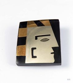 "Presented is a fantastic hand-made Mexican modernist piedra negra (black stone) brooch/pin from the mid-1900's. This appealing mixed metal pin features a man's face in profile. The eye appears to be an inlay of crushed green turquoise stone. The gold (brass) and black stripes bordering the face give him an Egyptian pharaoh look, don't you think? The piece is made from sterling silver and brass onlaid onto black resin and finished with a sterling silver back and bar pin with a rollover clasp. No Unique Handmade Black Brooches, Unique Black Brooches For Gifts, Face In Profile, Egyptian Pharaoh, Face Profile, Egyptian Pharaohs, Lapis Lazuli Stone, Metal Pins, Green Turquoise