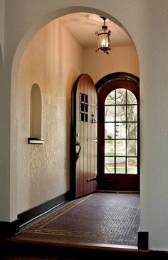 an arched doorway leading into a home