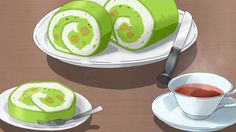 sushi rolls on a plate with a cup of tea and saucer next to it