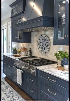 a kitchen with blue cabinets and white marble counter tops is featured in this article for the homeownershiper