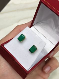 Featured here is a beautiful set of emerald cut Colombian emerald studs in fine 14K yellow gold. Displayed are medium-green emeralds with very good transparency, accented by a simple four-prong 14K gold mount, allowing for the emerald to be shown in full view. The earth mined, Brazilian emeralds have a desirable lush green color with excellent qualities. These earrings are ideal for everyday use and are the perfect accessory to any outfit. Total Carat Weight: 2.52cts Setting Style: Four Prong Se Green Baguette Cut Earrings For Gifts, Baguette Cut Emerald Earrings As A Gift, Emerald Cut Green Gemstone Earrings, Emerald Cut Green Earrings, Emerald Cut Emerald Earrings In Yellow Gold, Emerald Rectangular Earrings For May Birthstone, Classic Emerald Cut Emerald Earrings, Rectangular Emerald Gemstone Earrings, Rectangular Emerald Earrings Fine Jewelry