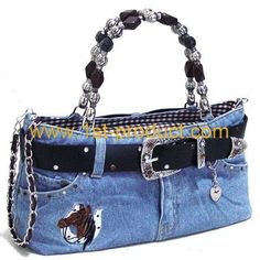 a handbag made out of jeans with chains on the handles and bottom, is shown