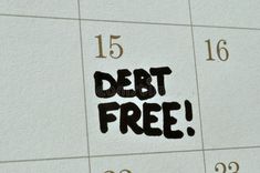 the word debt free written in black ink on a calendar