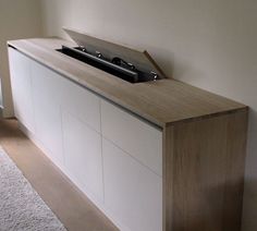 an entertainment center in the corner of a room with carpet on the floor and white walls