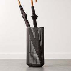 two umbrellas sticking out of a black container