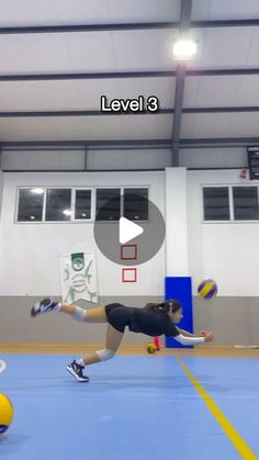 a woman is playing volleyball in a gym