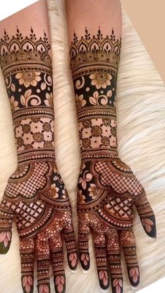 two hands with henna designs on them