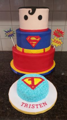 there is a superman cake on the counter