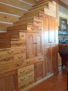 the stairs are made out of wood and have drawers on each side, along with an armoire