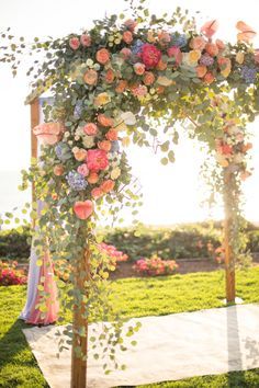 an outdoor wedding setup with flowers and greenery