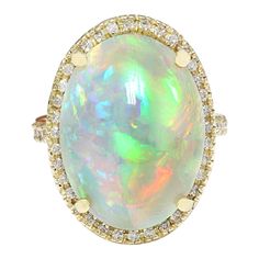 21.58 Carat Natural Opal 14K Solid Yellow Gold Diamond Ring Item Type: Ring Item Style: Cocktail Material: 14K Yellow Gold Mainstone: Opal Stone Color: Multicolor Stone Weight: 21.08 Carat Stone Shape: Oval Stone Quantity: 1 Stone Dimensions: 20.00x15.00 mm Stone Creation Method: Natural Stone Treatment Method: Not-treated Gemstone 1: Diamond Stone Color: F-G Stone Clarity: VS2-SI1 Stone Weight: 0.50 Carat Stone Shape: Round Stone Creation Method: Natural Stone Treatment Method: Not-treated Tota Opal Diamond Ring, Yellow Gold Diamond Ring, Diamond Fashion Rings, Gold Diamond Ring, La Face, Opal Stone, Oval Stone, Gold Diamond Rings, Natural Opal