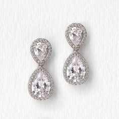 The sparkle and timeless shape of these pear drop earrings will have you feeling like a classic beauty at your next special occasion. Medium weight with good movement, these drops are the perfect earrings to wear with an elaborate headpiece accessory or dress. 18K White Gold over base metal Cubic Zirconia pave crystals Hypoallergenic post Height 0.9in(2.2cm) x Width 0.4in(1cm) Available in post earrings or clip-ons #E340 Drop Diamond Earrings, Teardrop Earrings Wedding, Wedding Rings Teardrop, Headpiece Accessories, Sterling Silver Name Necklace, Wedding Rings Solitaire, Jewelry Bridal, Drop Dangle Earrings, Bridal Gold Jewellery