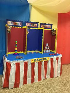 a table with two mirrors on top of it in front of a flag and wall