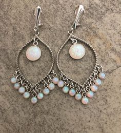 "Shop Opal Clip on Earrings. Do you have non pierced ears- these white opal chandelier earrings will be perfect touch of flair and splash of magnificent colors to your special occasion dress. Opal is an ideal gift as the birthstone of October. Non pierced clip on earrings are made from: - Sterling silver comfortable clip on - Rhodium plated connectors - 10mm lab created opal cabochons set in sterling silver bezel - 4 mm lab created cabochons set sterling silver bezel - Sterling silver rings Whit Gift For Bff, White Opal Earrings, Bridal Clip, Opal Bracelet, Earrings White, October Birthstone, Earrings Long, Opal Earrings, Opal Pendants