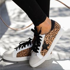 Kick Around In Our Dash Faux Suede Cheetah Sneakers! This Everyday Low-Top Sneaker Walks With An Eclectic Mix Of Cheetah Printed Faux Suede, A Grey Faux Suede Rounded Toe And White Leather Trim And Sole. Detailed With A Black Star Patch And Black Laces To Finish The Look. Styled With The Split Ankle Denim And The Highland Bag. Heel Height Approx. 1.25" Faux Suede Fabrication Faux Leather Trim Star Patch Gold Vent Holes Padded Foot Bed Rubber Soles Lace Up Closure True To Size Nwot Never Worn Siz Leopard Print Low-top Synthetic Sneakers, Trendy Leopard Print Leather Sneakers, Trendy Leopard Print Lace-up Sneakers, Casual Leopard Print Lace-up Sneakers, Fall Leopard Print Lace-up Sneakers, Leopard Print Lace-up Synthetic Sneakers, Cheetah Sneakers, Travel Sneakers, Black Wedge Sneakers