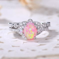 6x8mm Oval cut opal engagement ring set in white gold. The stones are Opal and VVS man made cz diamond. The center opal is about 6x8mm Oval Cut. The stones can be replace with other gemstones.For example,if you don't like the CZ accent,you can ask me replace it with tourmaline,aquamarine,diamond,emerald,sapphire... For custom making jewelry,it can be made in 2 different metal. 1,Solid gold,including 14/18k white/rose/yellow gold. 2,925 sterling silver with white/yellow/rose gold plated. High qua Wedding Rings Opal Silver, Real Opal Engagement Ring, Opal Wedding Ring Set White Gold, Silver Opal Engagement Ring, Opal And Pearl Ring, Unique Opal Engagement Rings, Pink Opal Engagement Ring, Opal Wedding Ring Silver, Fire Opal Ring Engagement