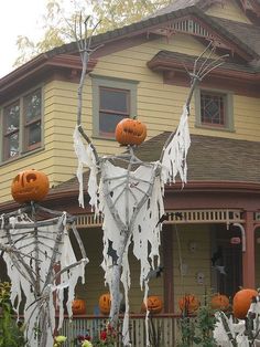 a house decorated for halloween with pumpkins and decorations