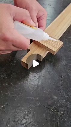 a person is cutting wood with a knife