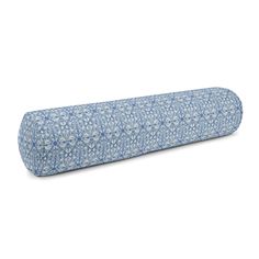 the blue and white floral print pillow is rolled up on it's back end