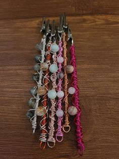 a close up of many different colored items on a wooden table with wires attached to them