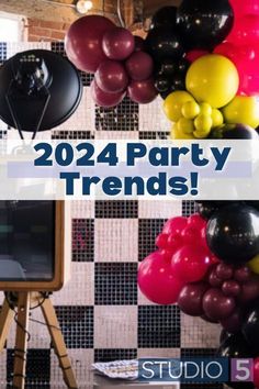 there are balloons hanging on the wall and in front of a tv that says party trend