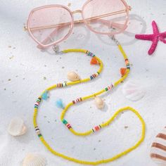 This Unique Glasses Chain Cowrie Puka Seashell Piece Is A Wonderful Addition To Your Wardrobe And Your Style; Sure To Get Lots Of Compliments! Y2k Vsco 90s Coastal Cottagecore Gshmhy00y0006fs Yellow Round Bead Necklaces For Summer, Yellow Necklaces With Colorful Beads For Summer, Yellow Round Beads Necklace For Summer, Summer Glass Necklace Fashion Accessory, Spring Beach Necklaces With Beaded Chain, Trendy Gold Glasses Chains For The Beach, Summer Fashion Glass Necklace, Summer Glass Necklace With Adjustable Chain, Adjustable Yellow Necklace For Beach