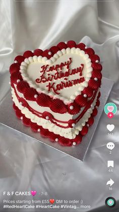 a heart - shaped cake with the words happy birthday koran written on it is sitting on a sheet