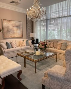 a living room filled with furniture and a chandelier