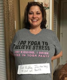 a woman standing next to a dog wearing a yoga t - shirt