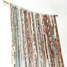 an assortment of fabric hanging on a wall