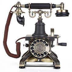 an old fashioned phone with two hands and one dial on the front, attached to a cord