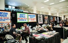 a group of people sitting around tables with posters on them