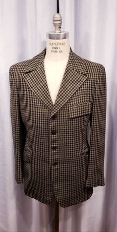 Beautiful houndstooth cloth two piece suit probably made in the 70's but exceptional quality. With the proper accessories it would be hard to tell this is not a true period piece, but the next best thing. Ready for the Dickens Faire or a period holiday party. Inside label reads: Mike Bain Inside pocket still has the Amalgamated Union Tag made in the USA the United States of America. Coat measures: Shoulders 18 1/2 inches, Chest 45 inches, sleeves 25 inches and length is 31 inches. Pants measure: Semi-formal Tweed Jacket With Houndstooth Pattern And Suit Collar, Semi-formal Houndstooth Tweed Jacket With Suit Collar, Semi-formal Tweed Jacket With Houndstooth Pattern, Semi-formal Houndstooth Tweed Jacket, Fitted Houndstooth Suits For Fall, Vintage Houndstooth Outerwear With Notch Lapel, Retro Tailored Tweed Jacket For Business, Tailored Retro Tweed Jacket For Business, Fitted Brown Houndstooth Blazer