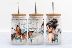 three painted mason jars with butterflies on the lids and one has a woman's face