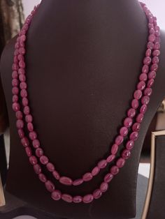 AAA 328 Carat Fine Quality Natural Ruby Smooth Plain 20 Inch Necklace Adjustable code Stone :Natural Ruby Shape :- fancy oval Necklace - 20 inch 2 line string Size :- 5x7mm to 8x11mm Weight :- 328 carat Polish :- Handmade Purity :- 100% Natural Gemstone color - red makes a great gift for your loved ones. It is known as the 'love stone' as the message it emits is the strong vibration of unconditional love, joy, warmth and healing. As quartz crystals are profound amplifiers of energy, it may help Elegant Gemstone Oval Beads, Handmade Elegant Oval Gemstone Beads, Elegant Oval Beaded Stone Necklaces, Elegant Oval Natural Gemstones, Elegant Beaded Necklaces With Oval Stones, Elegant Beaded Necklaces With Stones, Spiritual Oval Beaded Necklace With Gemstone Beads, Traditional Oval Necklaces With Polished Beads, Oval Natural Stone Beads For Gifts