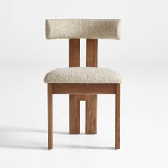 a wooden chair with a white seat cushion