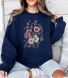 Fig Fruit Vintage Sweatshirt, Figs Floral Crewneck Pullover, Cute Womens Shirt, Retro Boho Fruit, Aesthetic Flower Sweater, Gift For Her A sturdy and warm sweatshirt bound to keep you warm in the colder months. A pre-shrunk, classic fit sweater that's made with air-jet spun yarn for a soft feel. * 50% cotton, 50% polyester * Pre-shrunk * Classic fit * 1x1 athletic rib knit collar with spandex * Air-jet spun yarn with a soft feel * Double-needle stitched collar, shoulders, armholes, cuffs, and hem Kelsey Miller, Fruit Aesthetic, Fig Fruit, Flower Sweater, Cute Womens, Aesthetic Flower, Womens Shirt, Sweater Gift, Fitted Sweater