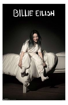 a woman sitting on top of a bed in front of a black and white photo