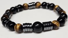 This bracelet features high quality 8mm Heishi Hematite, Black Obsidian, 10mm center Black Obsidian, and Tiger Eye beads, which are believed to be protective stones, and therefore nicknamed a triple protection bracelet. Please contact us if you would like a different bead size! We use strong NinjaCord for our stretch bracelets, which guaranteed not to break with normal use and normal activity.  Please note, that since we use genuine gemstones, there will be slight variations to the one pictured, Bracelets Patterns, Diy Bracelets Patterns, Tiger Eye Beads, Protection Bracelet, Eye Beads, Black Obsidian, Bracelet Patterns, Tiger Eye, Diy Bracelets