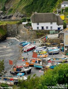 there are many small boats parked on the shore next to each other in this village