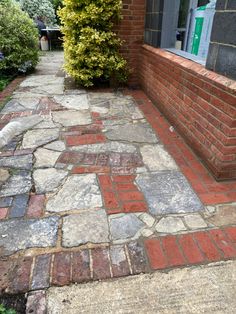 an old brick walkway in front of a house