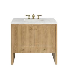 a bathroom vanity with two faucets on the top and one sink below it