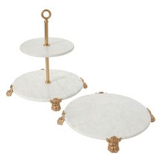 two white marble trays with gold handles on each side, one holding a candle holder