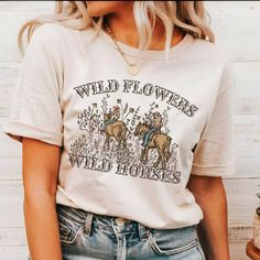 Wild Flowers Wild Horses Natural Shirt, Western Cowgirl Shirt, Trendy Western Shirt, Country Concert Shirt, Rodeo Graphic Shirt, Cute Cowgirl  Our T-shirts are made from premium materials and printed using advanced technology to ensure exceptional quality and comfort. Features: Premium brand: Gildan Soft Style Professionally printed using advanced technology Unisex size for a comfortable fit Made from soft, breathable cotton for all-day comfort Durable construction to withstand repeated wear and tear Easy Ordering: 1.Browse our design options. 2.Choose your size and color. 3.Choose the quantity you want. 4.Click "Add to Cart" to complete your purchase. Order Fulfillment: 💍Production time: 1-2 business days 💍Shipping time: 3-5 working days after production Return Policy: 💍Returns and exc Spring Graphic Print Band Merch Shirt, Spring Band Merch Shirt With Graphic Print, Spring Band Merch Shirt With Relaxed Fit, Spring Band Merch Shirt With Screen Print, Summer Band Merch Shirt With Custom Print, Summer Band Merch Top With Funny Print, Band Merch Tops With Custom Print, Band Merch Cotton Top With Funny Print, Printed Cotton Band Merch Top