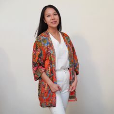 This is a washable printed batik robe/ kimono handmade by artisans, thick duster and home jacket. Because of the upcycled material and handmade nature of this item, each batik quilt kimono is not alike. The print will be of slightly different pattern and color but in variation of black, blue, pink, purple, green mix pattern. This thick quilted patchwork robe is handmade by artisans in Java using upcycled printed fabric from leftover fabric sourced from clothing manufacturer. Outer layer: 100% co