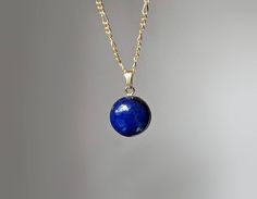 An elegant piece inspired by nature, this dainty necklace is guaranteed to make you stand out from the crowd on whatever occasion. Our lapis lazuli stone comes from Sri Lanka and measures 12mm, it has been set in a dainty smooth 14 karat gold filled round bezel. 💜 G E M S T O N E S 💜 * Gemstone: Natural Lapis Lazuli. * Size: 12mm. * Cut: Smooth Cabochon. * Origin: Asia * Birthstone Month: September (a perfect gift for the 9th Anniversary). * Meaning: Lapis Lazuli is known as "the stone of trut Royal Blue Lapis Lazuli Jewelry, Formal Lapis Lazuli Pendant Jewelry, Traditional Lapis Lazuli Pendant Necklace, Unique Lapis Lazuli Pendant Jewelry, Elegant Lapis Lazuli Oval Pendant Jewelry, Lapis Lazuli Pendant In Yellow Gold, Royal Blue Round Lapis Lazuli Jewelry, Royal Blue Lapis Lazuli Round Jewelry, 9th Anniversary