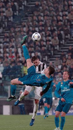 two soccer players jump for the ball during a game