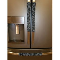 a stainless steel refrigerator with an ornate design on the door and handle is seen in this image