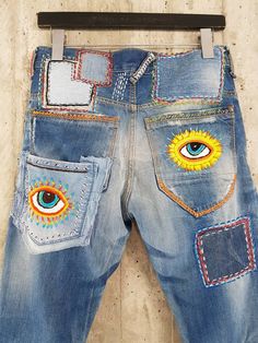 "Ready to send:Size 34 ,33,32,31 Unique vintage jeans with apcycled patches. One of a kind.. Hand made embroidery and unique painting .... ---Or---- Made to order, in any size, within 12 working days . If you need different size, please send me a message and I will make you a special and unique design within 12 working days. They are all different! No one will have the same one as you have! Hand painted, one of kind jeans. You pick your size, model (slime- boyfriend- high waist- low waist) and p Multicolor Straight Leg Denim Pants, Multicolor Denim Pants With Pockets, Retro Straight Leg Bottoms With Patch Pockets, Retro Tapered Leg Pants With Five Pockets, Multicolor Jeans With Pockets, Blue Retro Pants With Five Pockets, Retro Blue Pants With Five Pockets, Blue Straight Leg Festival Bottoms, Retro Multicolor Jeans With Pockets