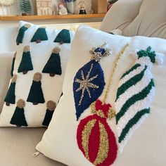 two pillows with christmas ornaments on them